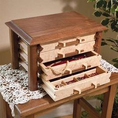 a wooden jewelry box sitting on top of a table