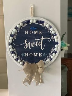 a blue and white sign that says home sweet home on the side of a wall