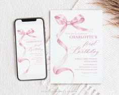 a pink birthday party card next to a cell phone on top of a white blanket