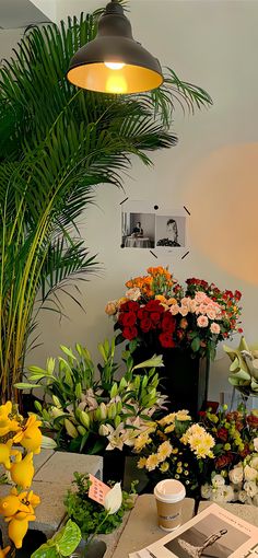 a bunch of flowers that are sitting on a table in front of a planter