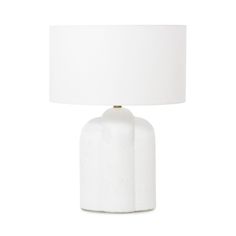 a white table lamp with a white shade on it