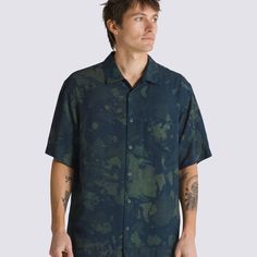 The Vans Camp Loose Collar Woven Shirt is a short sleeve shirt featuring a full buttondown front, moody allover print in shades of blue and green, and branded details like the pocket with a woven label on the chest.Earning the Vans Checkerboard Globe logo, this product is made up of at least 30% of one or a combination of recycled, renewable, and/or regenerative materials. 100% Ecovero Rayon fabric Allover print Buttondown front Patch pocket on left chest with woven label Straight hemline Loose Green Printed Short Sleeve Camp Shirt, Relaxed Fit Button-up Camp Shirt With Graphic Print, Printed Button-up Camp Shirt For Streetwear, Outdoor Button-up Camp Shirt With Pockets, Blue Printed Button-up Camp Shirt, Globe Logo, Back To School Shoes, Vans Checkerboard, Vans Store