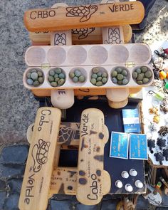 a table topped with lots of different types of stones and wooden pegs on top of it