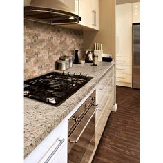 a stove top oven sitting inside of a kitchen