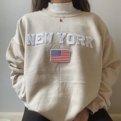 This very comfy and trendy New York sweatshirt is perfect for lounging in this cozy fall and winter season! This is also perfect for gifting to your loved ones! Please note that the letters are patches and are heat pressed, NOT embroidered. Purchasing this means you are aware and accept that. Our sweatshirts run in a UNISEX fit. The sweaters naturally have a slightly oversized fit giving extra room for moving around and comfort! For this reason, we highly recommend getting your true normal size Oversized Beige Letter Print Sweater, Oversized Beige Sweater With Letter Print, Trendy Winter Tops With Letter Embroidery, Winter Cream Sweater With Letter Print, Beige Crew Neck Sweatshirt For Fall, Cream Long Sleeve Sweatshirt With Letter Print, Cream Winter Sweater With Letter Print, Cream Long Sleeve Letter Print Sweatshirt, Cream Letter Print Sweater For Winter