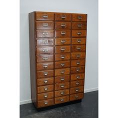 a large wooden cabinet with many drawers