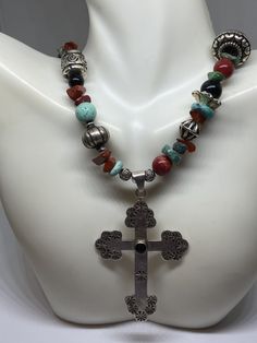 "This piece is so beautiful. It is a genuine, vintage, Taxco multi stone and sterling silver cross necklace. The necklace is 22 inches. The necklace features gorgeous, natural blue turquoise, red coral, carnelian, black onyx and sterling silver beads with a huge stamped sterling silver and black onyx cross. The stones are nuggets, round beads, rondelle beads. The sterling silver beads are stunning with etchings, including flowers, scrollwork, ribbed and other designs; some beads are shaped like Handmade Southwestern Cross Pendant Jewelry, Handmade Southwestern Style Cross Pendant Jewelry, Handmade Turquoise Cross Necklace Spiritual, Handmade Spiritual Turquoise Cross Necklace, Handmade Southwestern Cross Necklace, Southwestern Handmade Cross Necklace, Bohemian Cross Pendant Necklaces For Jewelry Making, Southwestern Style Silver Cross Necklaces, Bohemian Cross Pendant Jewelry