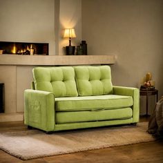 a green couch sitting on top of a rug next to a fire place in a living room