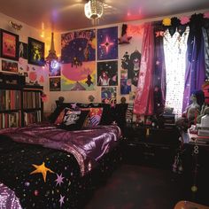 a bedroom decorated in black, purple and pink with pictures on the wall above the bed