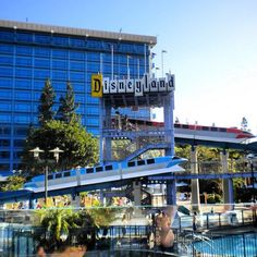 the disneyland land water park is in front of a large building with a sign on it