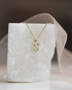 Baby Diamond Solitaire Necklace with Initial CharmCute twist on a classic diamond solitaire necklace• Material: Available in 14K Yellow Gold • Genuine Diamond: 0.03ct. VS Clarity F-H color• For bigger diamond size please message us we can customize for you Dainty Diamond Initial Necklace In White Gold, Dainty White Gold Diamond Initial Necklace, Classic Initial Necklace With Single Diamond For Gift, Classic Initial Necklace With Single Diamond, Minimalist Initial Necklace With Diamond Accents For Gift, Dainty Diamond Initial Necklace For Anniversary, Minimalist Initial Necklace With Diamond Accents As Gift, Dainty Initial Pendant Necklace With Single Diamond, Dainty Necklace With Single Diamond Initial Pendant