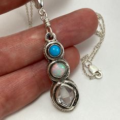 A beautiful one of a kind pendant that had been completely handcrafted solid fine (.999). The top stone is a high grade polished turquoise (5mm) from Arizona, USA.  At center is a firery Ethiopian Opal gem with multiple color flash (5mm). Below is set an AA+ grade, water clear Herkimer diamond Quartz crystal (7x9 mm). This gorgeous, naturally double terminated, stone was mined in Middleville, NY. Total pendant dimensions are 12x50 mm. I make all of my jewelry myself. Each piece is hand fabricate Artisan Turquoise Dangle Necklace Gift, Spiritual Turquoise Necklace With Natural Stones In Sterling Silver, Spiritual Turquoise Necklace With Round Pendant, Spiritual Turquoise Necklace With Natural Stones, Unique Untreated Turquoise Necklace Gift, Unique Untreated Turquoise Necklace As Gift, Unique Untreated Turquoise Necklace For Gift, Spiritual Turquoise Round Pendant Necklace, Artisan Untreated Round Pendant Jewelry