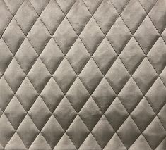 an up close view of a quilted material with diamond shapes on the back and sides