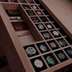 an open drawer with many different watches in it