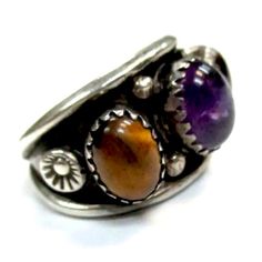 Signed- Mike Platero Vintage Navajo Amethyst Tigers Eye Sterling Silver Ring Size 7 1/8 Us Markings “Mp” Merged Fonts Hallmark For Mike Platero, Navajo Tested As Sterling Silver Verified Amethyst Verified Tigers Eye Band Width ~ 5 - 13mm Total Weight ~ 7.8 Grams Amethyst ~ 10 X 5 X 2.5mm (2) Tigers Eye ~ 9 X 4 X 2.5mm #3710 Purple Multi-stone Bohemian Jewelry, Purple Bohemian Multi-stone Jewelry, Bohemian Amethyst Ring With Gemstone Accents, Bohemian Amethyst Ring, Unique Cabochon Gemstones, Bohemian Multi-stone Oval Gemstones, Bohemian Oval Multi-stone Gemstones, Bohemian Purple Rings With Natural Stones, Bohemian Amethyst Ring With Natural Stones