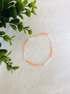 This orange beaded summer anklet is a cute accessory for any outfit and adds a pop of colour. It makes a great gift  for teens and adults. Colorful Beaded Anklets For Spring Gift, Trendy Beaded Anklets For Summer, Trendy Summer Anklets With Round Beads, Casual Beaded Bracelets With Small Beads For Summer, Spring Gift Anklets With Colorful Beads, Trendy Tiny Beads Anklets For Summer, White Round Bead Anklets For Summer, Trendy Beach Anklets With Tiny Beads, White Round Beads Anklet For Summer