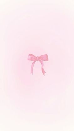 a pink bow on top of a light pink background with room for text or image