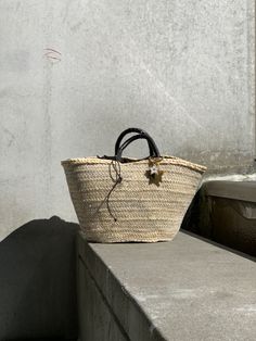 The Brigitte bag is our very modern version of the traditional Panier basket. The basket, handmade by artisans in Spain in palm leaf straw, is covered in a metallic gold mesh, and the short handles coiled in brown leather. It is lined in dark brown cotton fabric, with leather drawstring with metal star charms. The bag is finished with a Cuckoo B keychain featuring a buffalo horn star made in Vietnam, a handmade in Argentina ceramic white star and the Cuckoo B bronze tag. It is inspired on Summer Luxury Handwoven Straw Bag With Double Handle, Luxury Handwoven Double Handle Straw Bag, Elegant Straw Bag With Woven Leather And Round Handle, Luxury Straw Bucket Bag With Braided Handles, Elegant Straw Bag With Round Handle In Natural Color, Luxury Straw Basket Bag With Braided Handles, Luxury Natural Bag For Market, Luxury Natural Color Bag For Market, Luxury Straw Bag With Woven Leather Basket