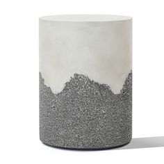 a gray and white vase sitting on top of a table