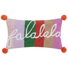 a colorful pillow with the word falabba written in multicolored stripes and pom poms