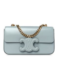 This is an authentic CELINE Shiny Calfskin Triomphe Chain Shoulder Bag in Ice Blue. This chic shoulder bag is crafted of smooth calfskin leather in blue. The bag features a gold chain strap, and a blue Triomphe snap button closure on the crossover flap that opens to a matching leather interior with a patch pocket. Blue Calf Leather Shoulder Bag For Evening, Classic Blue Calf Leather Shoulder Bag, Chic Blue Calf Leather Bag, Timeless Blue Shoulder Bag For Evening, Luxury Blue Bag With Chain Detail, Luxury Blue Bags With Chain Detail, Luxury Blue Bags With Chain, Luxury Blue Chain Bags, Elegant Calf Leather Shoulder Bag With Chain Strap