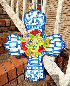 a cross made out of ceramic sitting on the steps