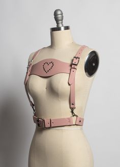 This harness belt is made in thick, strong, colorful PVC or leather. Detachable lederhosen-style front panel with rivet heart detail . Buckles at front and shoulder straps. Fit is adjustable with buckles. Silver-toned nickel plated steel hardware.Shown in blush pink leather.Available in many leather and PVC colors. Neon Pink and Neon Orange PVC are UV/Blacklight reactive! All pieces are MADE TO ORDER, standard sizes XS-4XL. If your measurements fall outside these standards or you are unsure of w Animation Practice, Evil Pics, Harness Outfit, Concert Style, Fall Outside, Harness Belt, Concert Fashion, Colorful Accessories, Leather Diy