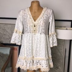 New Never Used Mint Condition Size S-M U White V-neck Lace Dress With Lace Trim, Bohemian V-neck Dress With Scalloped Lace, Cream Lace V-neck Mini Dress, White Lace Patchwork Mini Dress, White Lace Patchwork Beach Dress, Lace Crochet V-neck Dress For Vacation, Vacation Lace Crochet V-neck Dress, White Mini Length Dress With Lace Top, Off White Scalloped Lace Dress