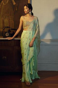 Light green pre-draped concept saree with tear drop beads butti embellishments and ruffle saree skirt hem. Paired with an embroidered brocade noodle strap padded cami blouse.
Components: 2
Pattern: Embroidery
Type Of Work: Beads
Neckline: Round Neck
Sleeve Type: Noodle Strap
Fabric: Blouse: Brocade Silk 
Saree Skirt: Cotton Satin
Pallu: Satin Organza   
Color: Green
Other Details: 

Model height: 5 ft 8 inches, wearing size XS
Closure: 
Blouse : Side zipper
Saree Skirt: Side hook with zipper
Len Embellished Pista Green Pre-draped Georgette Saree, Green Embellished Pre-draped Saree For Wedding, Pista Green Georgette Pre-draped Saree With Dupatta, Eid Pista Green Dola Silk Pre-draped Saree, Elegant Pista Green Dola Silk Pre-draped Saree, Bollywood Style Pista Green Pre-draped Saree For Festive Occasions, Green Dola Silk Pre-draped Saree For Designer Wear, Embellished Green Sharara With Traditional Drape, Designer Chanderi Pre-draped Saree In Pista Green