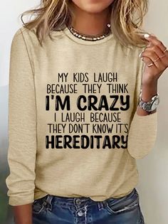 a woman wearing a sweater that says, my kids laugh because they think i'm crazy