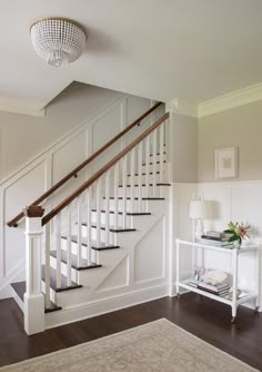 there is a white stair case in the living room