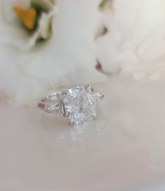 a close up of a diamond ring on a table