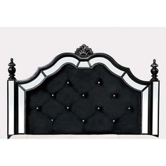 a bed with black and white headboard and foot board on top of the frame