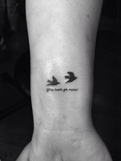 two birds with the words you can't go now on their wrist