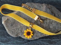 "Velvet ribbon choker with sculpted flower. Material of flower is polymer clay. Material of findings are zinc alloy in gold plated. Each petal of flower made by hand Dia flower about 18 mm/ 0.7 \" Length of choker is adjustable: 9-11 inches/ 22,8- 27,9 cm 10-12 inches/ 25,4 - 30, 5 cm 11-13 inches/ 28-33 cm 12-14 inches/ 30.5- 35.5 cm 13-15 inches/ 33-38 cm 14-16 inches/ 35.5 cm-40.5 cm 15-17 inches/ 38 cm- 43 cm 16-18 inches/ 40.6 cm- 45.7 cm 17-19 inches/ 43 cm - 48 cm 18-20 inches/ 45,7-50,8 Yellow Choker Necklace As A Gift, Yellow Choker Necklace For Gift, Flower Decoration Choker Necklace Gift, Flower Decoration Choker Necklace For Gift, Flower Decorated Choker Necklace For Gifts, Adjustable Choker Necklace With Flower Decoration, Adjustable Flower Decoration Choker Necklace, Gold Choker With Flower Charm, Adjustable Gold Necklace With Flower Decoration