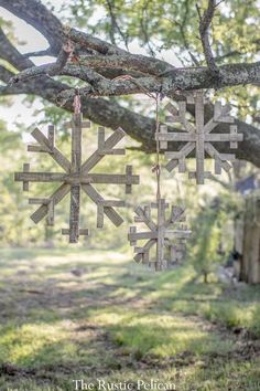 wooden snowflakes hanging from a tree branch