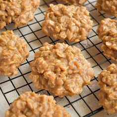 several cookies cooling on a wire rack with some oatmeal in the middle