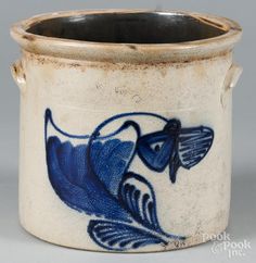 a blue and white vase with a bird on it