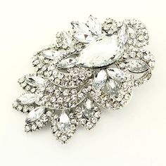 "Beautiful large silver crystal brooch jewelry embellishment, which can be used for your DIY project - Glam, Vintage inspired wedding, bridal brooch bouquet, ring pillow, invitations, cake decorations, event decor, crafts, scrap booking and much more! Size: 3\"H x 2 1/2\"W Stone color: Clear Metal: Silver plated Weight: 60 grams This rhinestone brooch can be ordered with pin in the back to add to wedding gown or dress sash, to wire into brooch bouquet, or any number of other craft projects; or w Silver Crystal Brooch With Sparkling Stones, Silver Crystal Brooches With Sparkling Stones, Elegant Crystal-embellished Brooches For Weddings, Silver Rhinestone Brooches For Wedding, Glamorous Silver Brooch For Wedding, Elegant Crystal Embellished Brooches For Wedding, Elegant Crystal-embellished Wedding Brooches, Silver Wedding Brooches With Rhinestones, Crystal Brooch For Wedding Jewelry