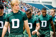 a group of young men standing next to each other on a field