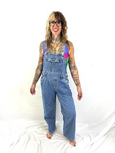 Nice overalls Size medium. Great vintage shape 100% cotton Made in Bangladesh Lying flat: 18" across waist 21" across hips 50" top to bottom front center 28" inseam High Rise Medium Wash Cotton Overalls, High Rise Cotton Overalls In Medium Wash, Vintage Light Wash Overalls With Pockets, Vintage Cotton Denim Jumpsuit In Medium Wash, Retro Medium Wash Cotton Jeans, 90s Inspired Medium Wash Cotton Jeans, 90s Inspired Light Wash Cotton Jeans, Retro Dark Wash Cotton Denim Jumpsuit, Vintage Denim Blue Cotton Jumpsuit