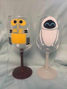 two wine glasses decorated to look like cartoon characters