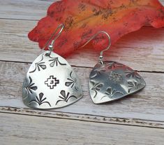 These earrings are truly unique and fun. They are 1 1/2" shield hand stamped in a native american style.  The sterling is hand stamped and has a light patina. Light weight, everyday wear earrings, Shipped in gift worthy packaging. We guarantee you are satisfied with your purchase, you can send the item back within 10 days in original packaging and condition to receive a full refund. We pride ourselves on shipping quickly. The packaging will be gift-worth and will be shipped USPS via first class mail to your doorstep. If you would like to upgrade to priority mail or express, those options are available at the checkout process. We have been in business for over 25 years in Texas. Please email southernwingsjewelry@gmail.com  Earring shields are 1 inch The Overall earring length is about 1 1/2 Concho Dangle Earrings For Gift, Festival Concho Dangle Jewelry, Adjustable Stamped Dangle Earrings, Adjustable Concho Earrings For Festival, Southwestern Teardrop Jewelry For Festivals, Southwestern Style Concho Drop Earrings, Silver Concho Earrings As A Gift, Traditional Concho Earrings For Gift, Artisan Concho Earrings As Gift