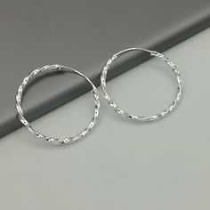 IMPORTANT **Please go through all the pictures i have posted for a listing with a ruler, on a model, on my hand, to get an exact idea of the actual size of the item.These are dramatic twisted sterling silver hoop. Dimensions: 2 mm X 35 mm Weight: 3.8 gm Price listed is for a PAIR of hoops. These earrings are made of 925 hypoallergenic sterling silver. Most of my pieces come with a 925 stamp. Can be packaged in a gift box. I can include a personal message from you if needed You are welcome to con Hoops Silver, Hoop Earrings Silver, Evil Eye Earrings, Jewelry Minimalist, Eye Earrings, Bohemian Earrings, Big Earrings, Silver Accessories, Sterling Silver Hoops