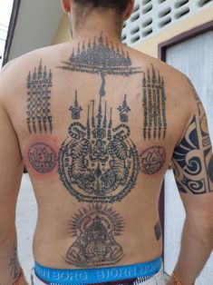 the back of a man with tattoos on his body