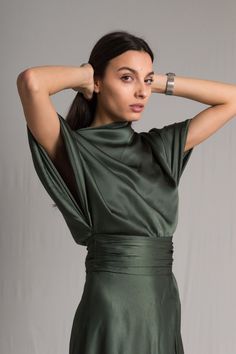 Word on the street is you want to stand out but still look chic. We’ve got you covered girl. The Fiore Dress is an asymmetrical dark sage green silk number, with a cowl neckline and ruched waist detailing. It means business on the right side and party on the left. It takes us 15 hours to make this dress. Check out the pricing transparency HERE. PLEASE ALLOW 1-3 BUSINESS DAYS FOR PRODUCTION Festive Cocktail Dress, Dark Sage Dress, Edgy Formal Dresses, Pear Clothes, Dark Green Dresses, Ethereal Fashion, Smooth Jazz Music, Green Silk Dress, Dark Sage Green