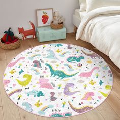 a child's bedroom with a round rug in the shape of dinosaurs