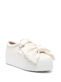 Viktor & Rolf x Superga bow-detail Sneakers - Farfetch White Flat Platform Sneakers With Laces, Chic White Platform Sneakers, Elegant Lace-up Sneakers For Spring, Elegant Synthetic Sneakers With Textured Sole, Elegant Cream Low-top Sneakers, Chic White Sneakers With Textured Sole, Chic White Sneakers With Rubber Sole, Elegant Synthetic Sneakers For Spring, Chic White Flat-heeled Sneakers