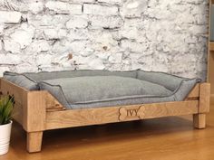 a dog bed made out of wood and fabric