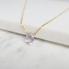 Add a touch of elegance with this handmade necklace, featuring a natural Lavender Quartz gemstone dangling in a handmade frame on a simple dainty chain. Choose your length for a choice to wear it as a choker or a long layered necklace. Simple, minimal, and elegant all-in-one necklace. Makes a great gift to add to any gemstone lover's collection. Perfect to gift for Christmas, Valentine's Day, Mother's Day, and more! Gemstone: Lavender Quartz, Scorolite Gemstone Size: 10.0 mm Gemstone Shape: Pan, Delicate Everyday Gemstone Necklaces, Delicate Gemstone Necklaces For Everyday, Delicate Everyday Gemstone Necklace, Faceted Lavender Teardrop Jewelry, Faceted Lavender Briolette Jewelry, Elegant Amethyst Dangle Necklaces, Elegant Teardrop Birthstone Necklace, Elegant Purple Dangle Necklaces, Handmade Elegant Drop Crystal Necklaces